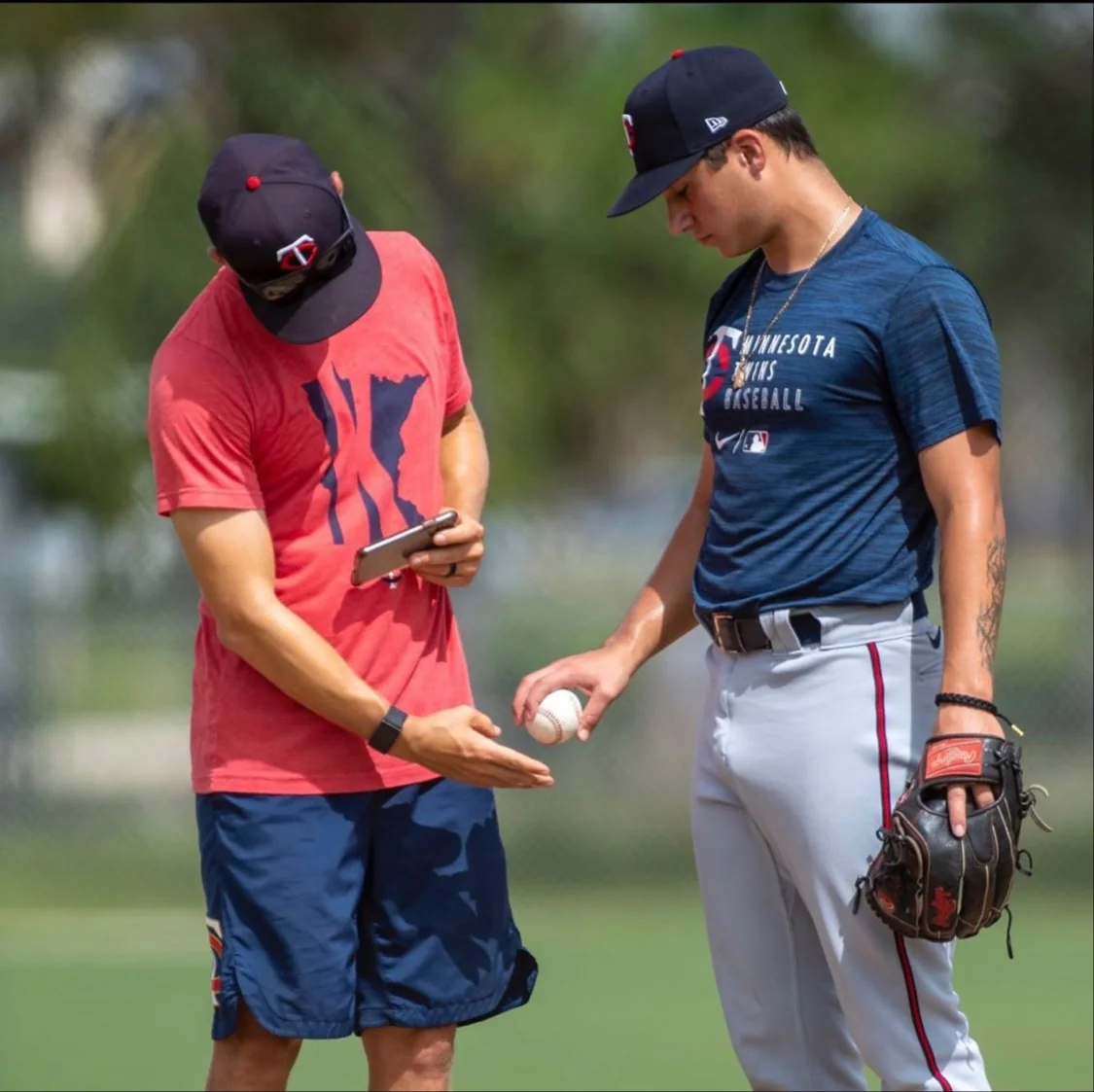 Jared Gaynor coaching a pitcher on a grip